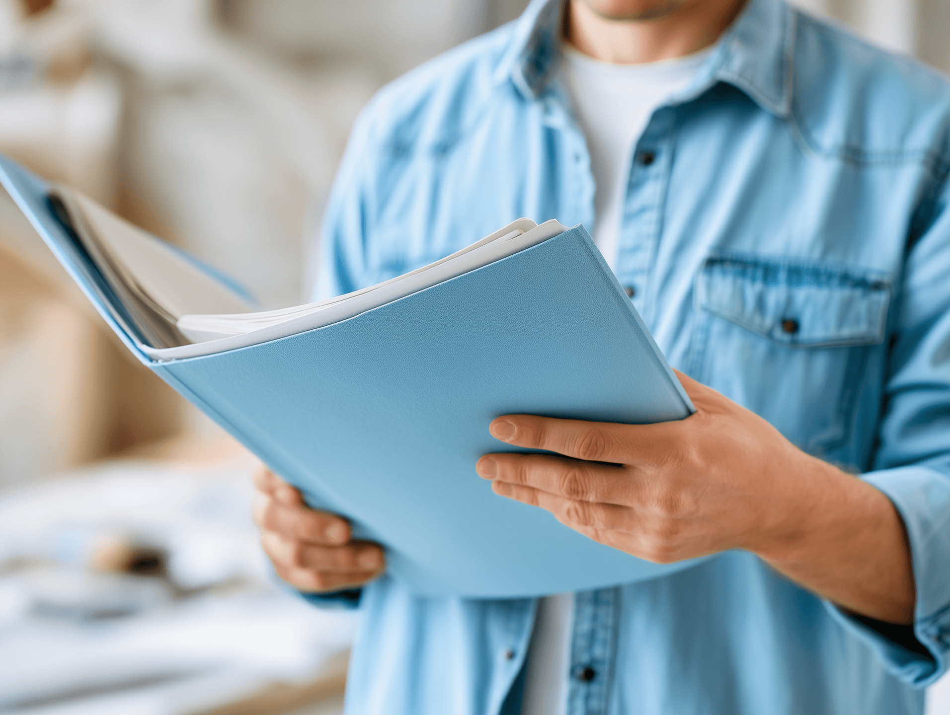 A professional reviewing organized project documents in a folder